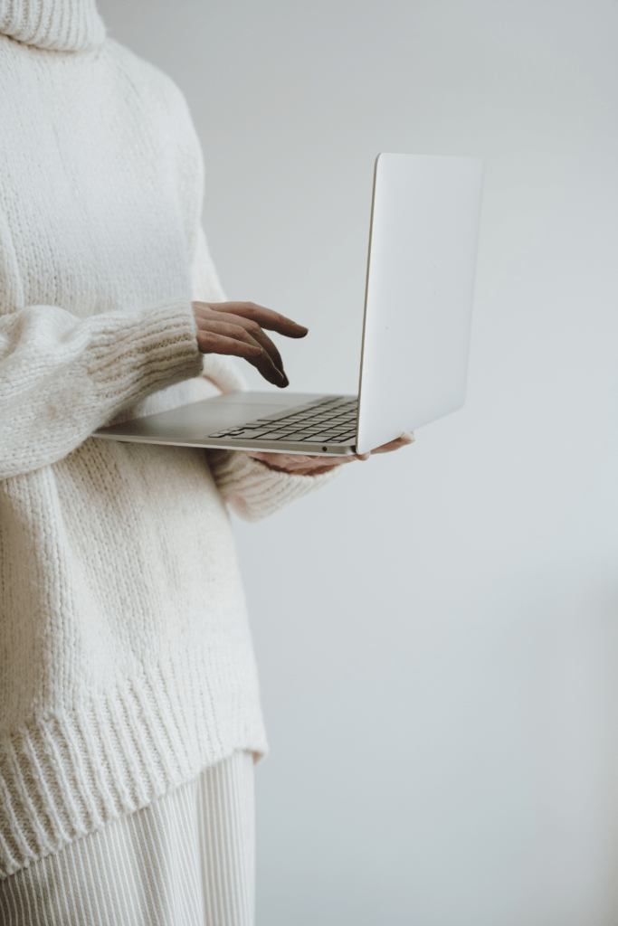 woman holding laptop typing