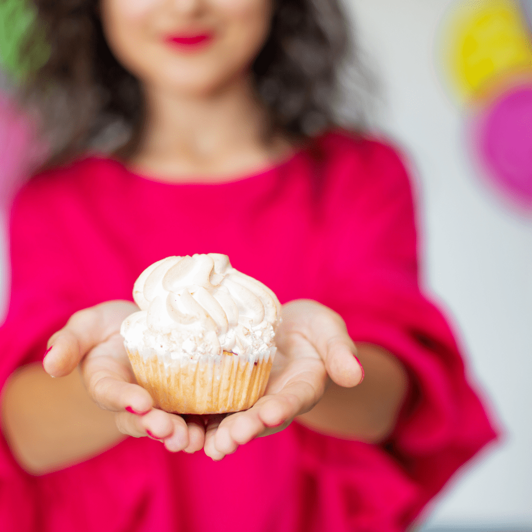 woman holding cupcake