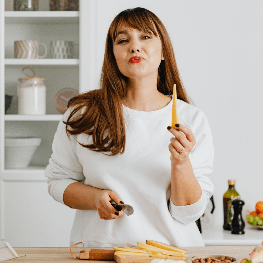 woman holding food in kitchen