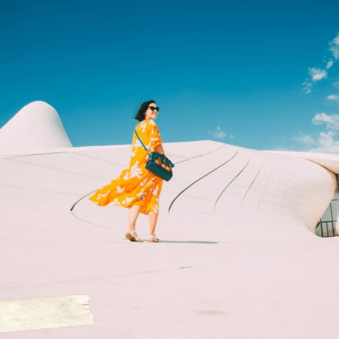 woman wearing yellow dress traveling in the desert