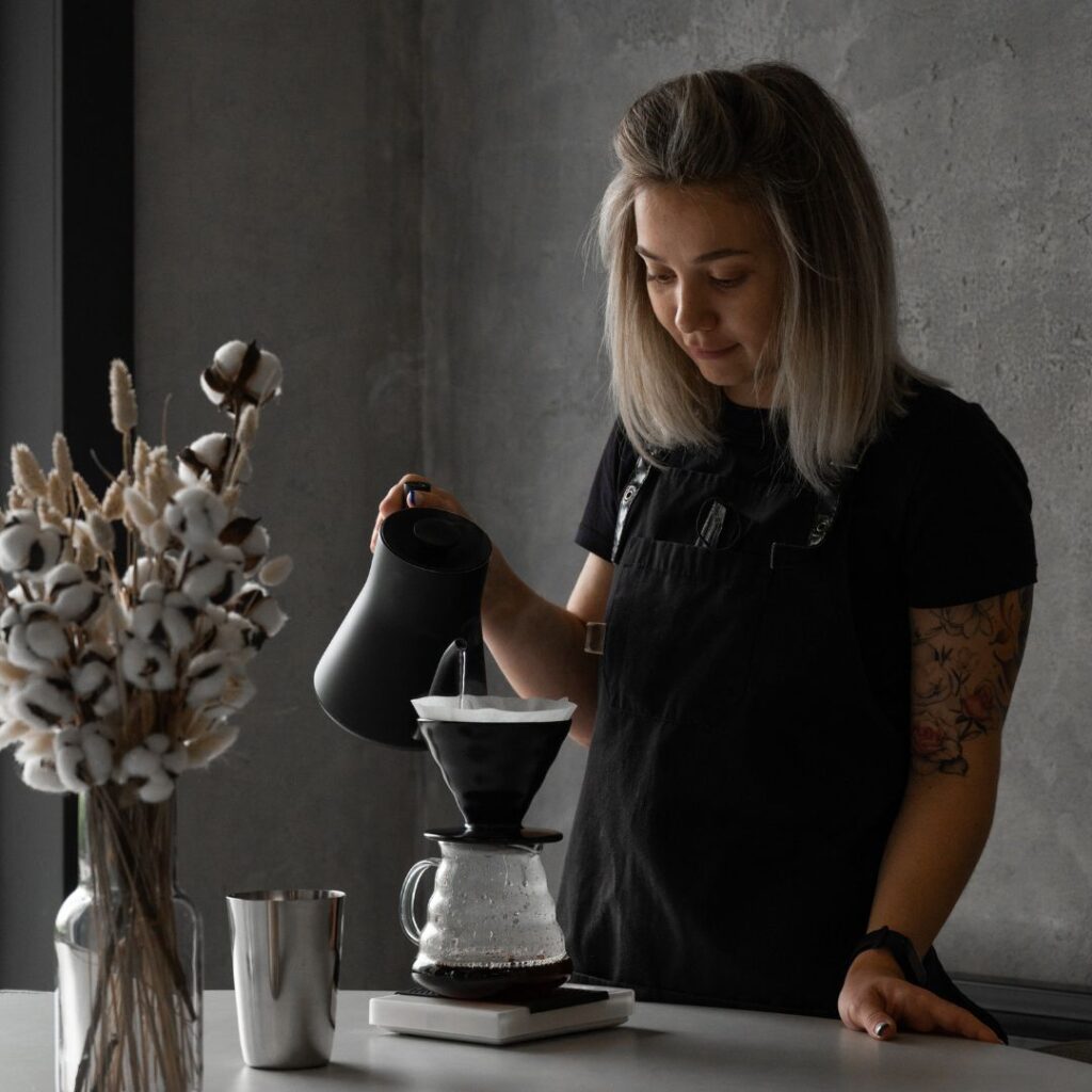 woman using pouring over coffee maker